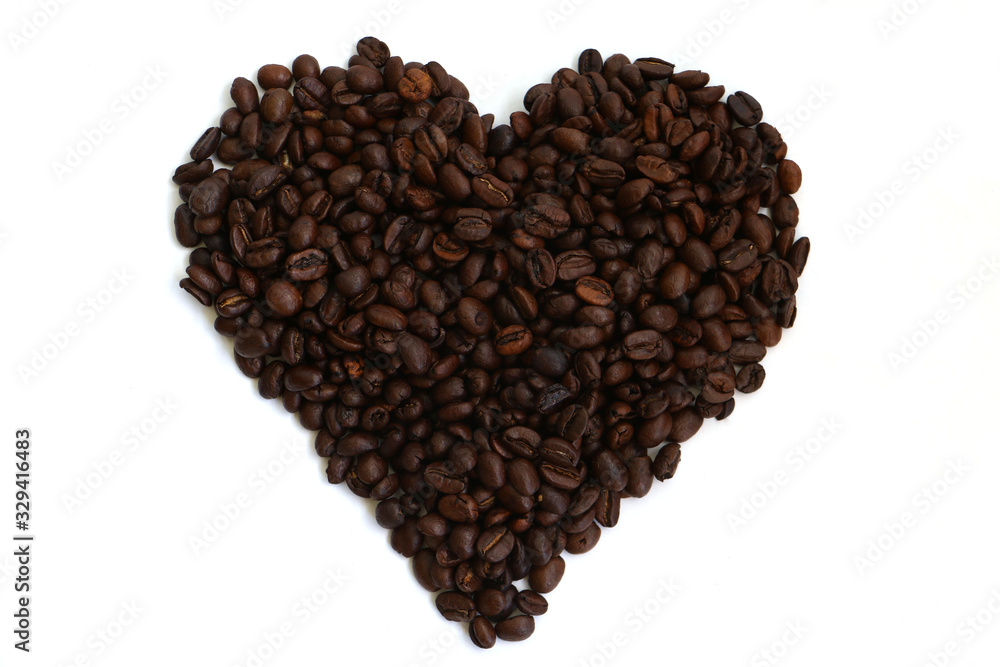 Isolated coffee beans in the shape of a heart on a white background denoting a love or passion for coffee Isolated coffee beans in the shape of a heart on a white background denoting a love or passion for coffee