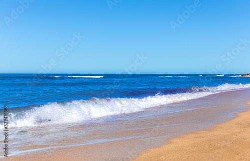 Foamy surf on a sandy tropical beach