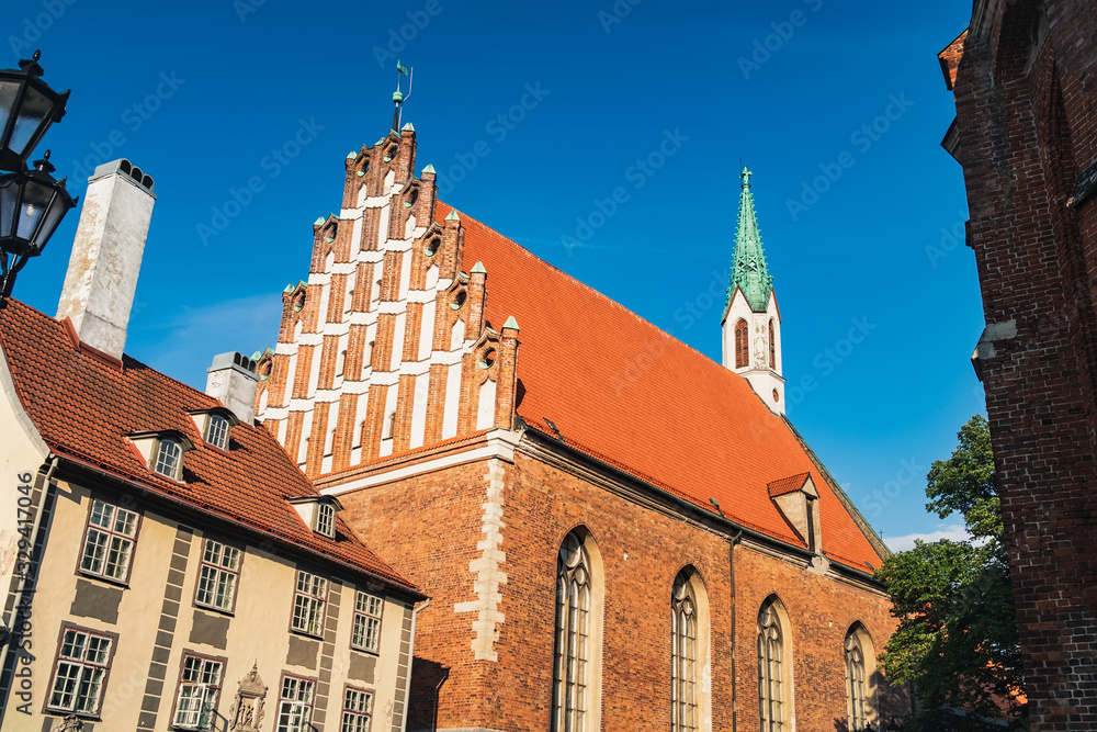 St John Church in Old Town of Riga, Latvia. Aged Latvian lutheran Church under blue sky