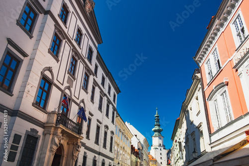 Aged Slovak houses Michalska street and Saint Michael Gate under blue sky, Old Town of Bratislava city, Slovakia © sonatalitravel
