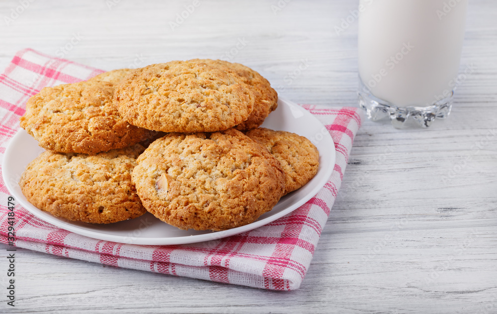 pastry cookies on a white wooden board and a glass of milk pastry cookies on a white wooden board and a glass of milk
