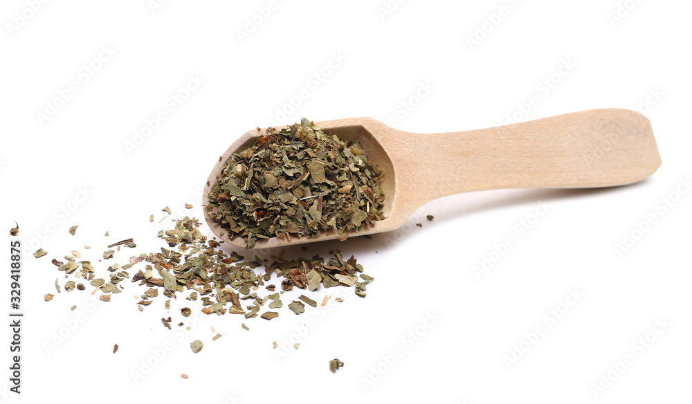 Basil dried spice in wooden spoon isolated on white background Basil dried spice in wooden spoon isolated on white background