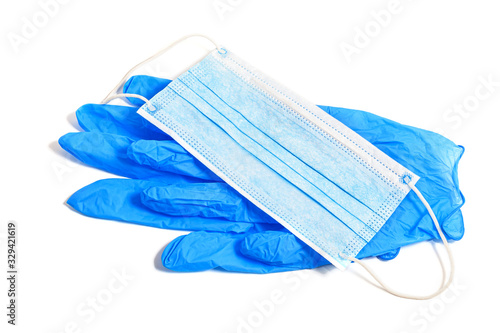 Rubber medical gloves and mask. Disposable protective subjects. Remedies. A pair of thin blue medical latex gloves and face shield on a white background.