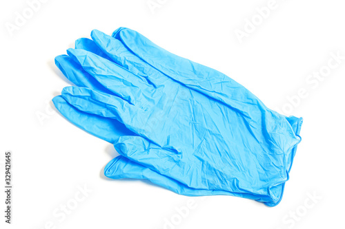 A pair of thin blue medical latex gloves on a white background.