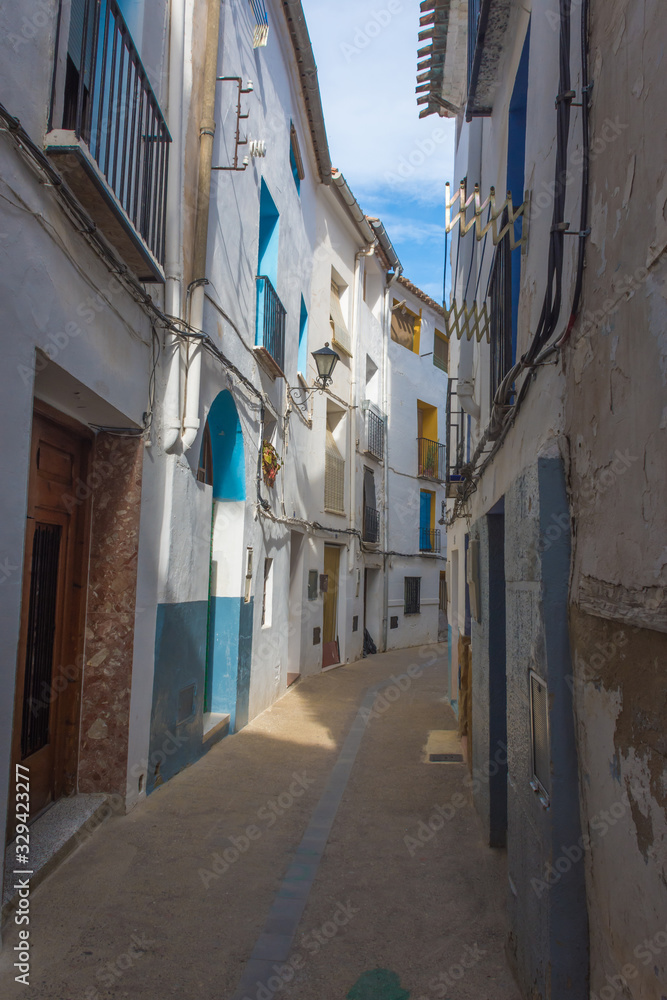 Fototapeta premium Colorful street with old buildings in Chelva, valencian community, Spain