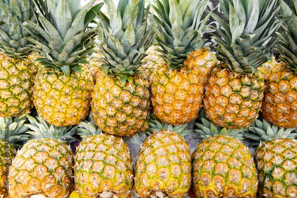 Ripe pineapples in the market close-up. Ripe pineapples in the market close-up.