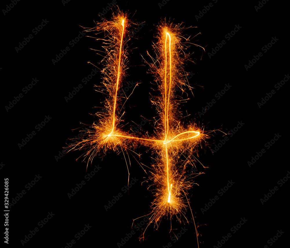 number four written with a sparkler on a black background