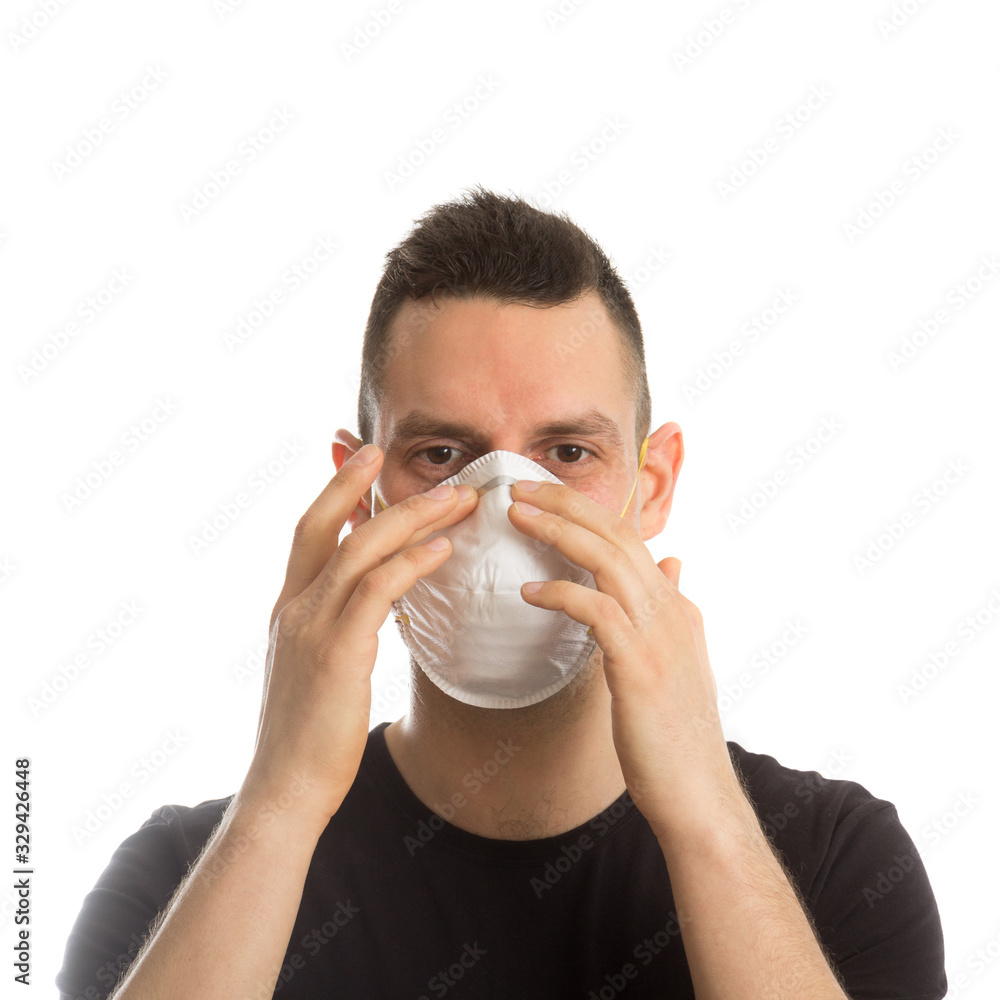 A European man with a medical mask on his face. A man in a protective mask is protected from the virus. A European man with a medical mask on his face. A man in a protective mask is protected from the virus.