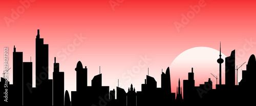 City skyscrapers on sunset background. Abstract city against the sky and the sun at sunset