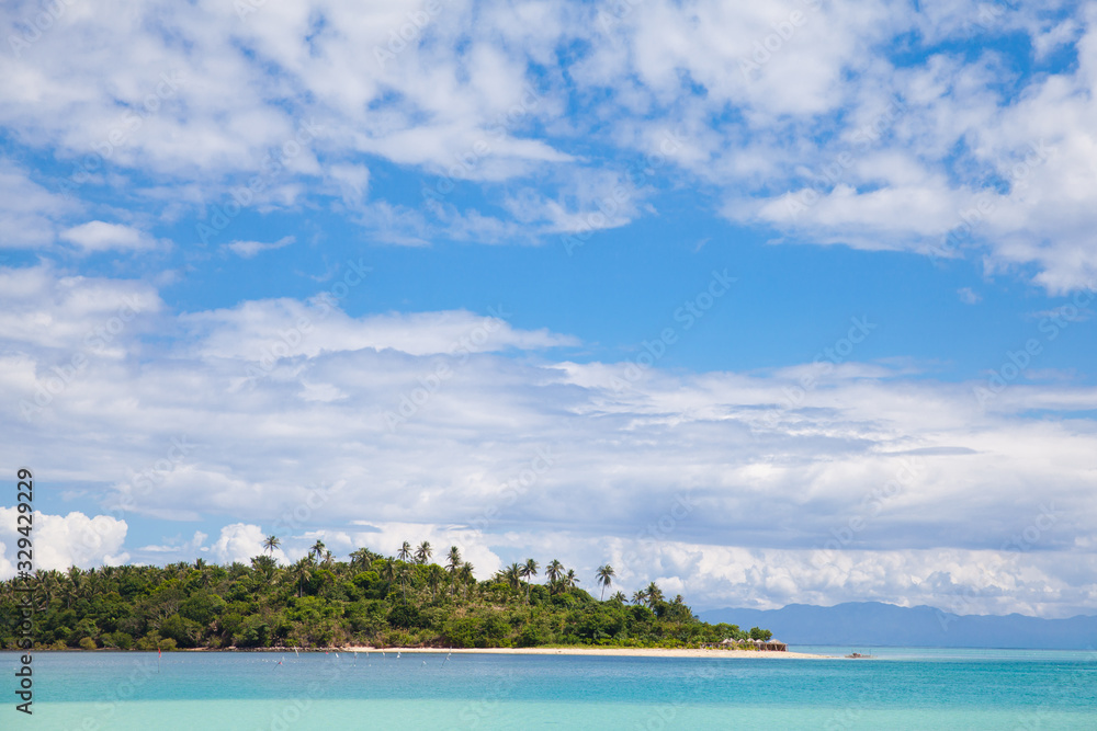 Tropical island with a white sandy beach. Caramoan Islands, Philippines.