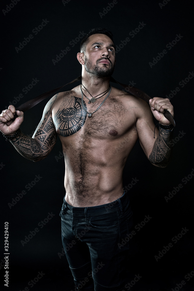 fitness model topless. healthcare lifestyle. body strong abs. Wild masculine beauty. macho. brutal and sexy. muscular bodybuilder with body tattoo. athletic male hold strong belt. full of power