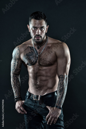 Be strong. muscular bodybuilder with body tattoo. athletic male show abdominal muscles. fitness model topless. healthcare lifestyle. body strong abs. Wild masculine beauty. macho. brutal and sexy