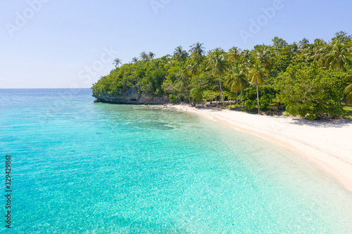 Fototapeta Naklejka Na Ścianę i Meble -  Tropical island with a white beach. Island with palm trees and white sand, top view. Summer and travel vacation concept. Mahaba Island, Philippines.