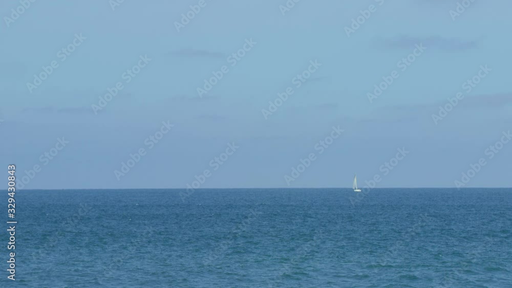 Slow Motion White Sailboat On Blue Pacific Ocean Slow Motion White Sailboat On Blue Pacific Ocean