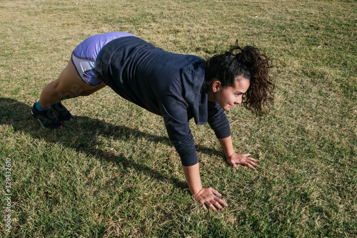 young girl exercising in the grass