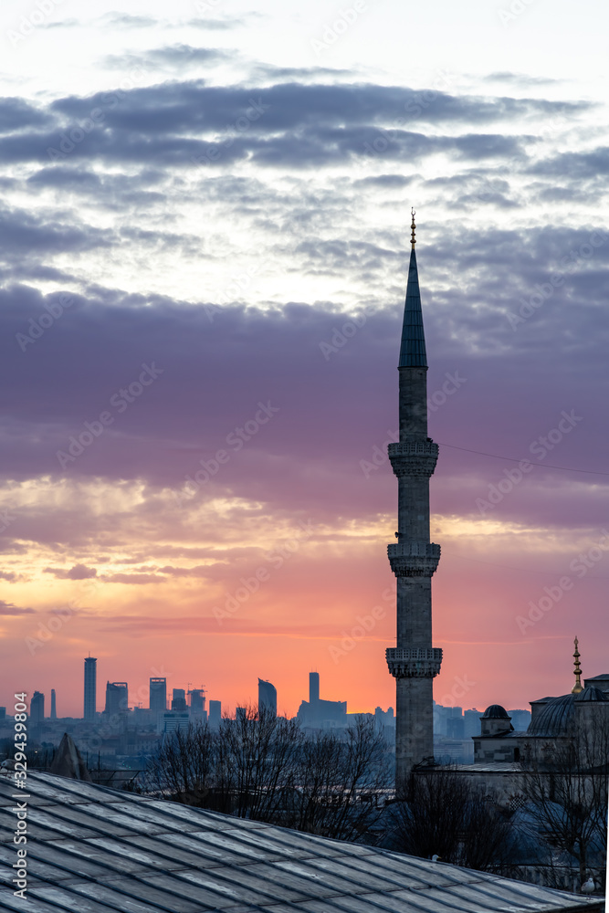 Fototapeta premium View on one of the six minarets of the Blue Mosque at sunrise in Istanbul. Built by Sultan Ahmet I in 1603-1617.