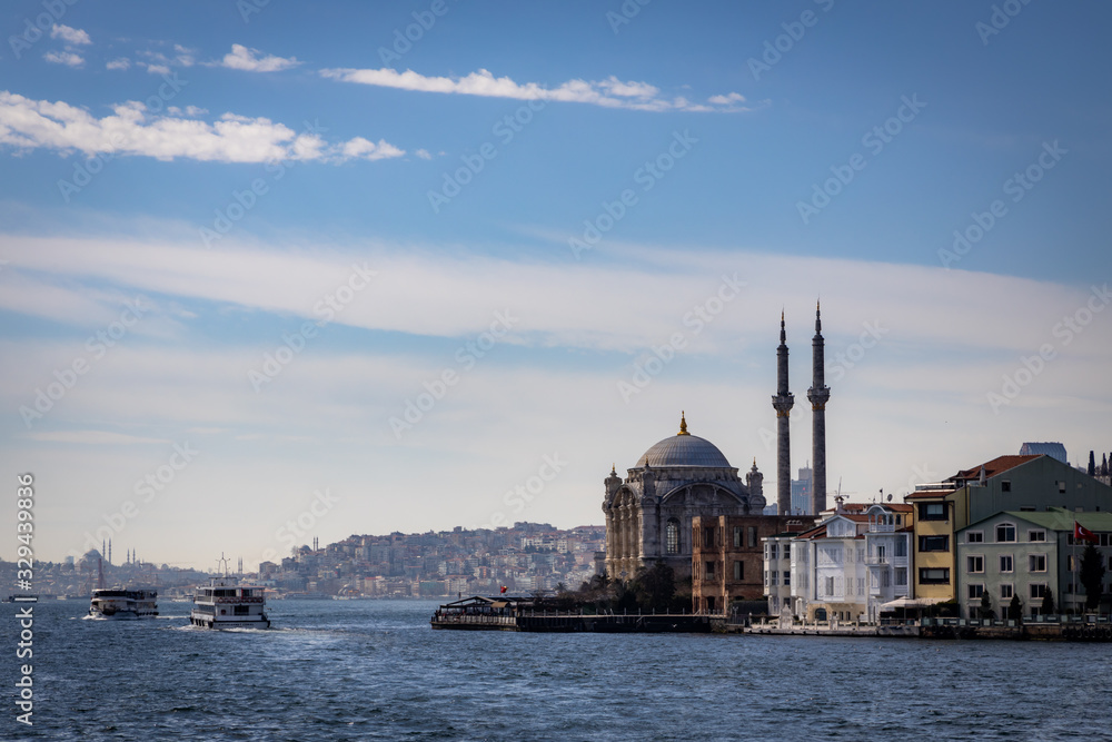View on the Ortaköy mosque with the city of Istanbul on the background. Built in 1854 on the shores of the Bosphorus, next to the 15 July Martyrs Bridge, which connects Europe to Asia.