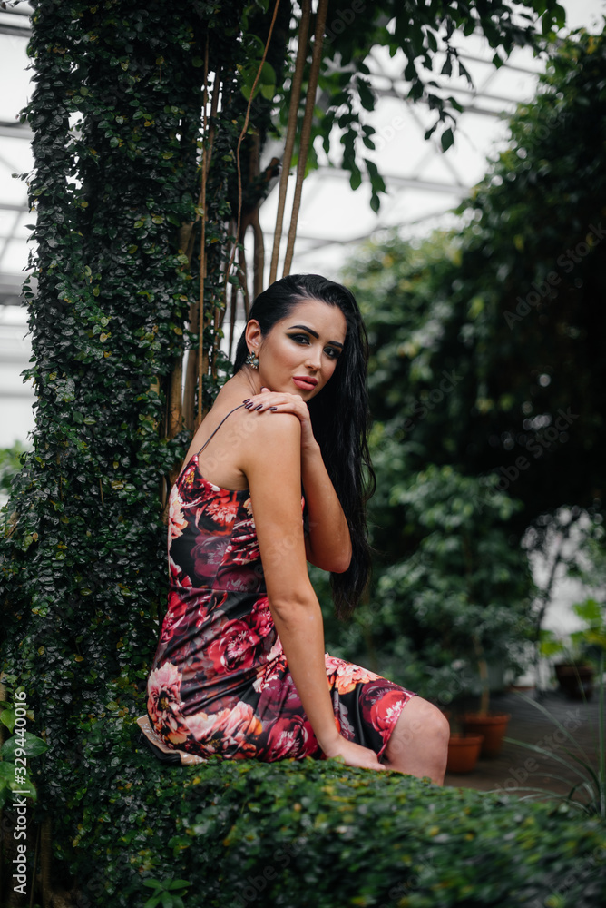 A young beautiful brunette posing among dense thickets of jungle and rainforest. Spa A young beautiful brunette posing among dense thickets of jungle and rainforest. Spa