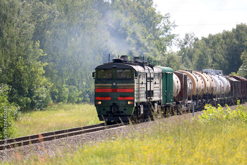 Naklejka premium diesel locomotive with freight train