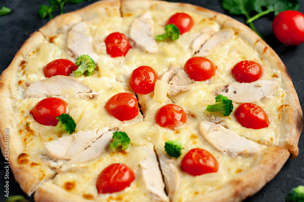 delicious pizza with pineapple, broccoli, tomatoes, mozzarella cheese, chicken fillet on a stone background delicious pizza with pineapple, broccoli, tomatoes, mozzarella cheese, chicken fillet on a stone background