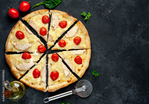 delicious pizza with pineapple, tomato, mozzarella, chicken fillet on a stone background with copy space for your text