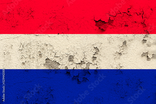 national flag of the modern state of Netherlands on an old historical wall with cracks, concept of tourism, travel, emigration, global business