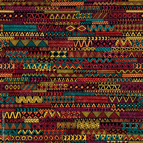 Seamless geometric pattern in patchwork style. Ethnic and tribal motifs. Grunge texture. Bohemian ornament for textiles. Vector illustration.