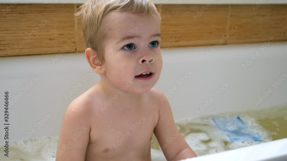 Happy Cute Child Washes Himself with Shampoo and Washcloth in Bathtub. Bathes In Bathroom. Slow motion 0.5 speed 60 fps Happy Cute Child Washes Himself with Shampoo and Washcloth in Bathtub. Bathes In Bathroom. Slow motion 0.5 speed 60 fps