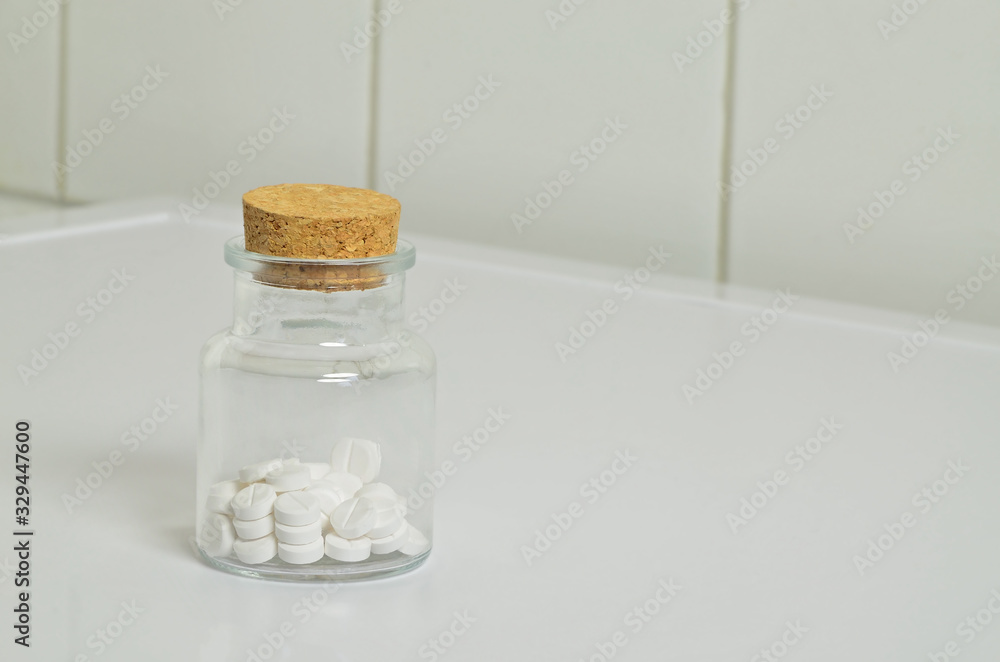White Pills in a Vial, close up, isolated on white Background White Pills in a Vial, close up, isolated on white Background