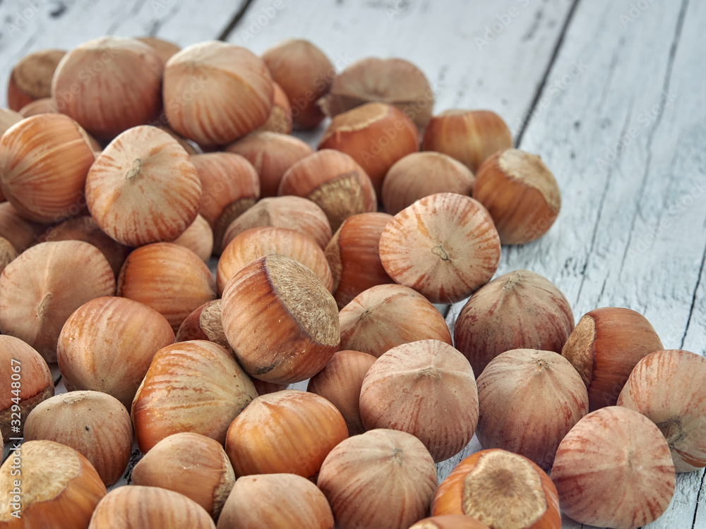 Hazelnuts lie on light wooden boards.Useful hazelnut for health. Hazelnuts lie on light wooden boards.Useful hazelnut for health.