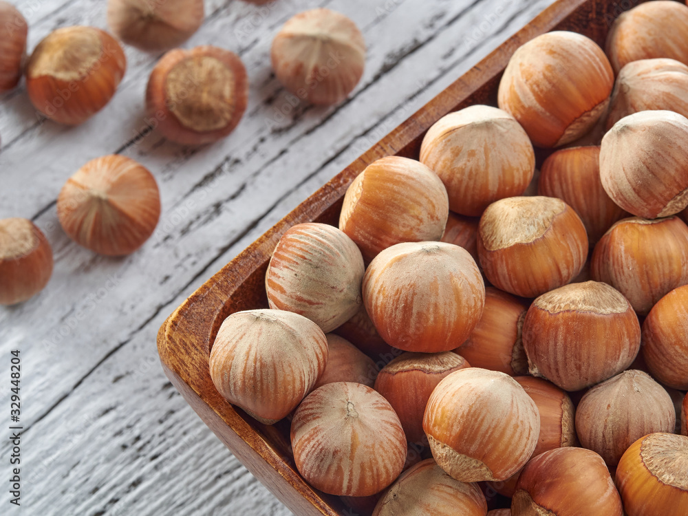 Hazelnuts lie on light wooden boards.Useful hazelnut for health. Hazelnuts lie on light wooden boards.Useful hazelnut for health.