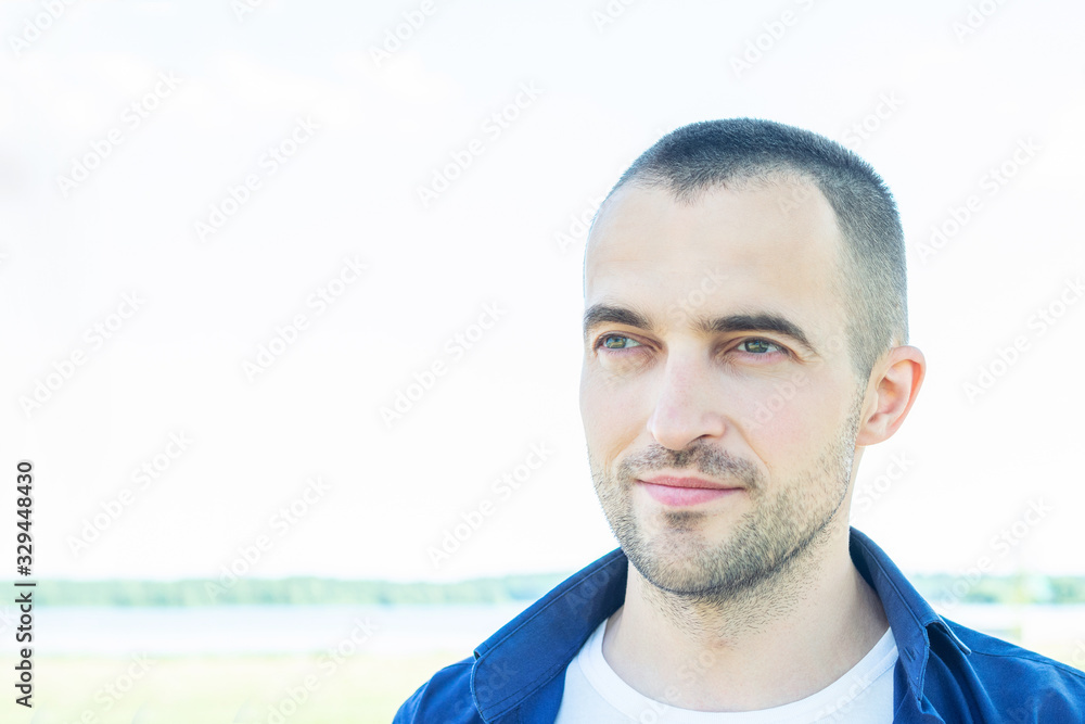 Handsome young man in Park in summer, portrait, toned, copy space