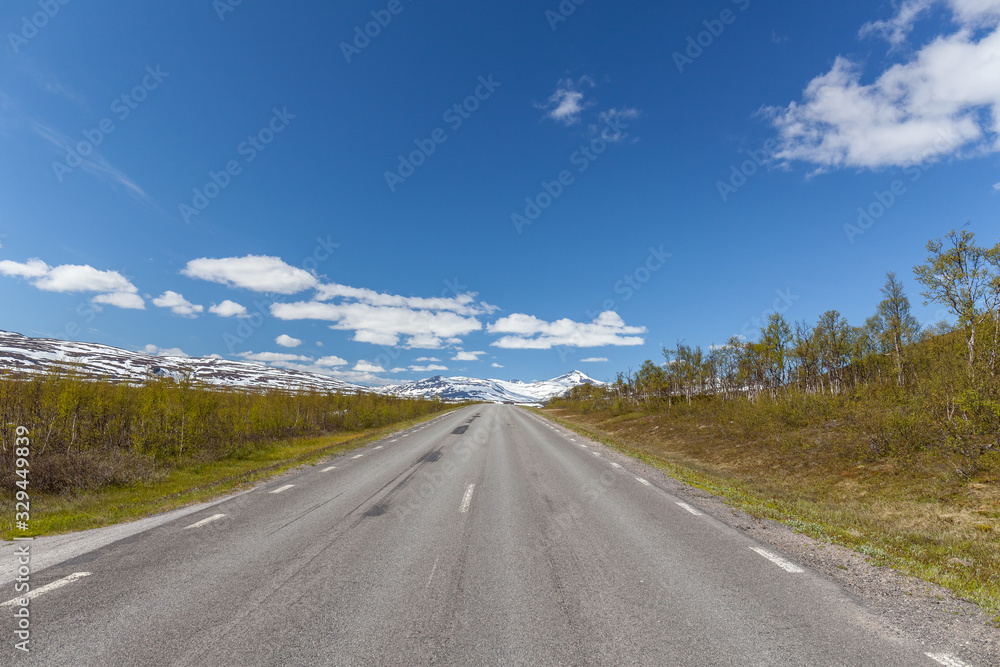 road passing in a valley between mountains in Sweden, selective focus road passing in a valley between mountains in Sweden, selective focus