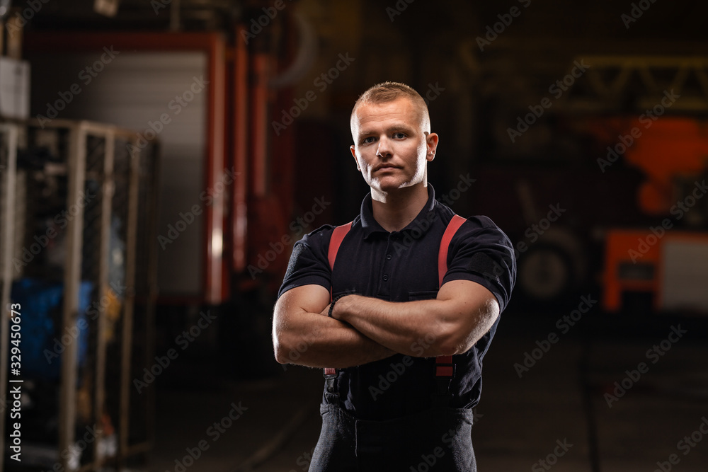 professional muscular firefighter portrait wearing shirt and red