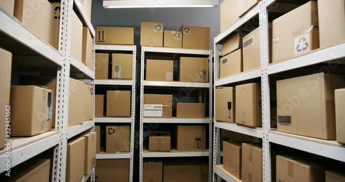 Schilderij op canvas Interior of post office with shelves and carton boxes