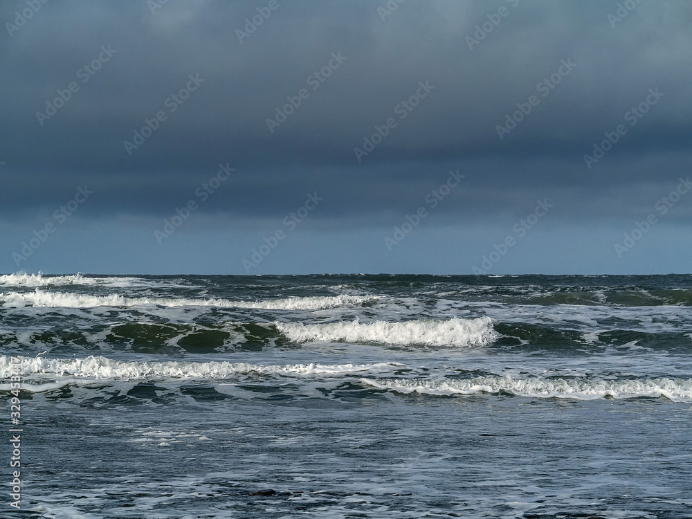 Oceans waves, low clouds in the sky, Nobody, nature background.