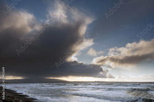 Atlantic ocean waves at Strandhill beach county Sligo, Ireland, Dramatic clouds in a bird shape. Nobody.