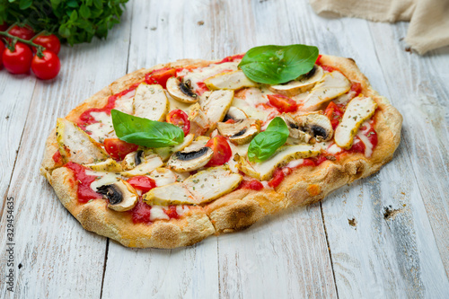 Pinsa with chicken and mushrooms and basil, rome pizza.