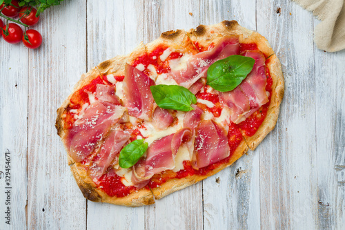 Pinsa with parma ham rome pizza on white wooden board