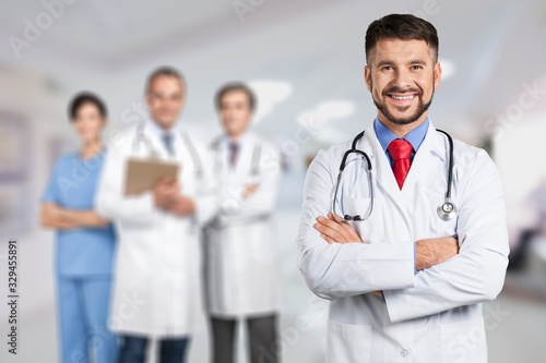 Handsome doctor portrait on hospital background