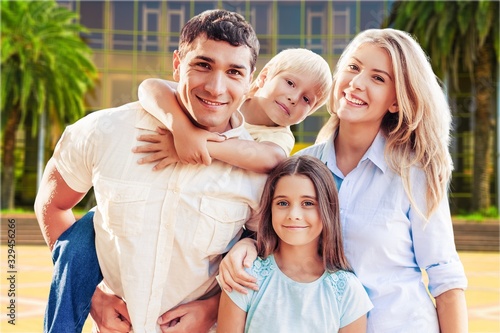 Young family at home smiling at the camera