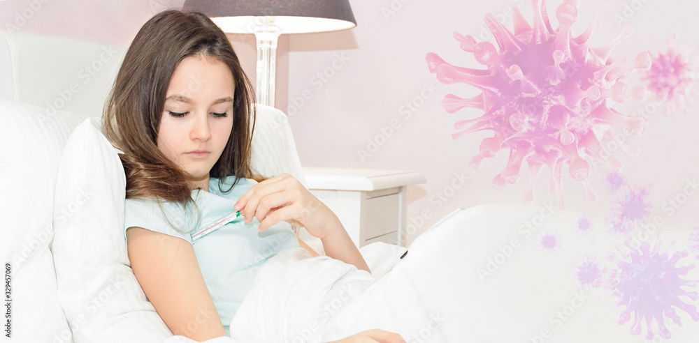 Teenage girl sick with virus with fever stays in bed, measures fever with thermometer Teenage girl sick with virus with fever stays in bed, measures fever with thermometer