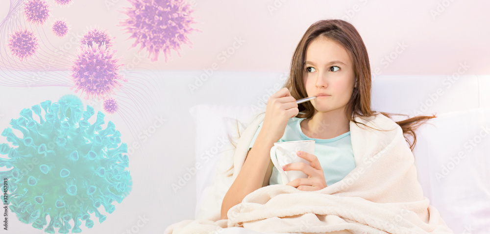 Teenage girl sick with virus with fever stays in bed, measures fever with thermometer Teenage girl sick with virus with fever stays in bed, measures fever with thermometer