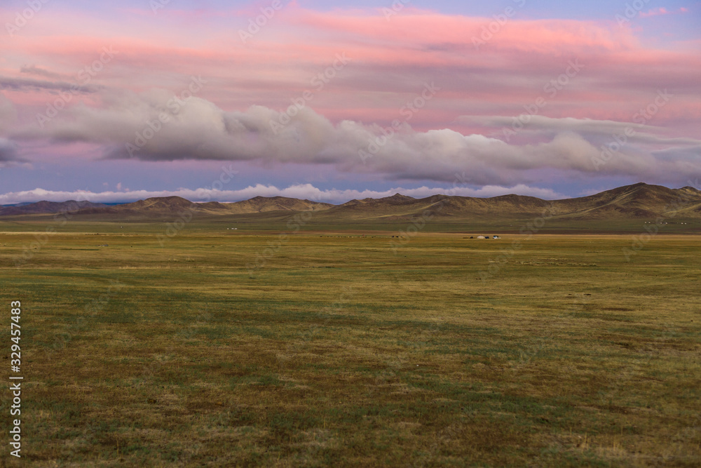 Steppe grasslands at cloudy dusk sunset