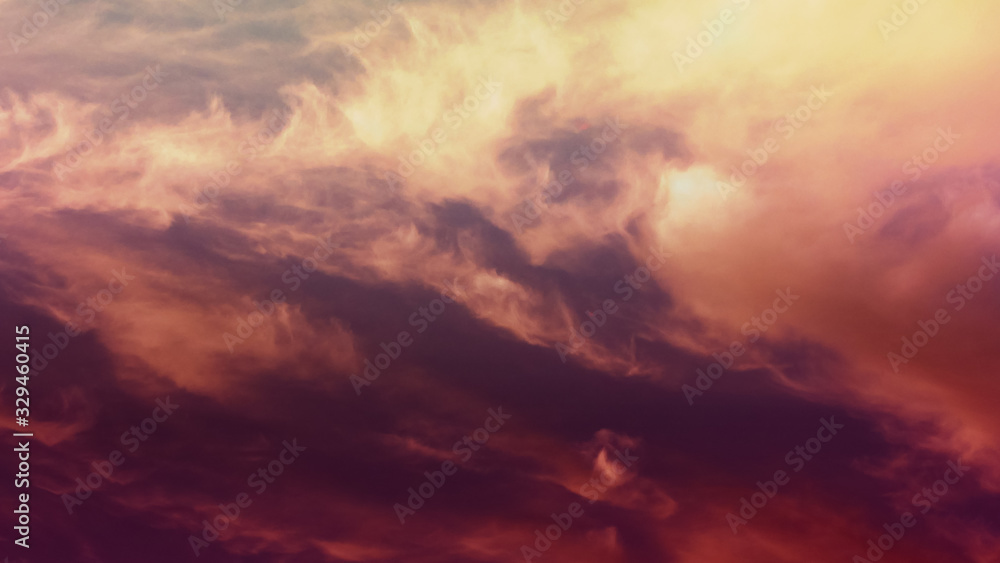 Red, yellow clouds. Cosmically beautiful, bright, color majestic Sky at dawn or evening. Abstract epic background. Twilight sky. Idyllic peaceful nature background on nightfall.