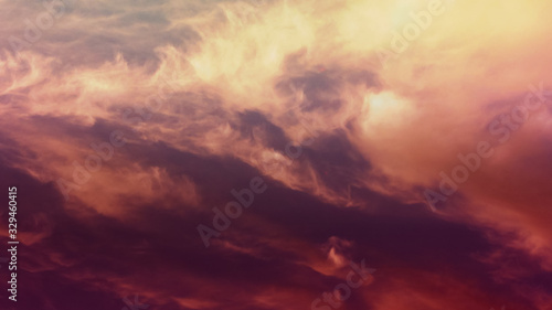 Red, yellow clouds. Cosmically beautiful, bright, color majestic Sky at dawn or evening. Abstract epic background. Twilight sky. Idyllic peaceful nature background on nightfall.