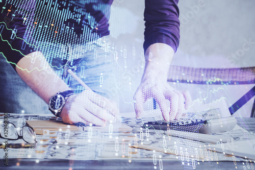 Multi exposure of man standing and planing investment with stock market forex chart.