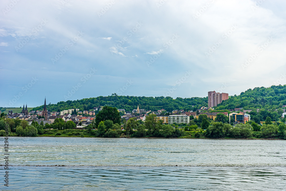 Fototapeta premium Germany, Rhine Romantic Cruise, a body of water with a city in the background