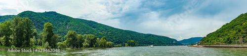 Germany, Rhine Romantic Cruise, a large body of water with a mountain in the background panorama © SkandaRamana