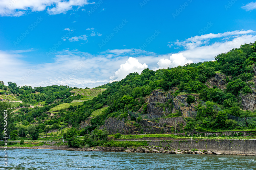 Germany, Rhine Romantic Cruise, a body of water with a mountain in the background Germany, Rhine Romantic Cruise, a body of water with a mountain in the background